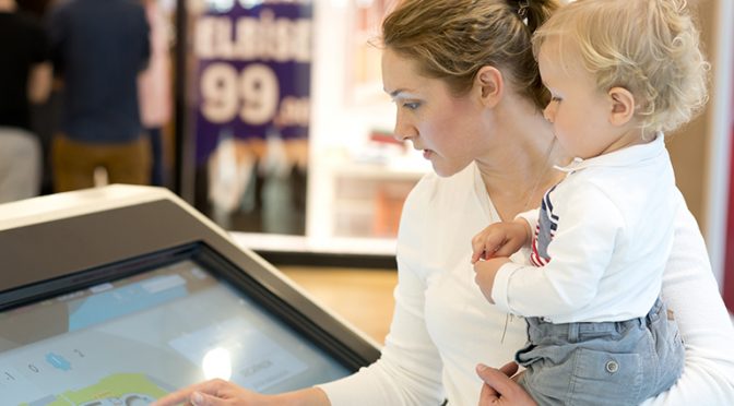 Mother and son using information display