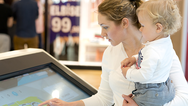 Mother and son using information display