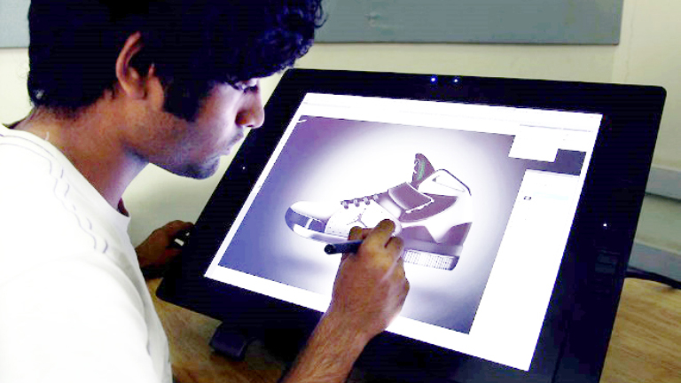 Person using a stylus on a drawing tablet