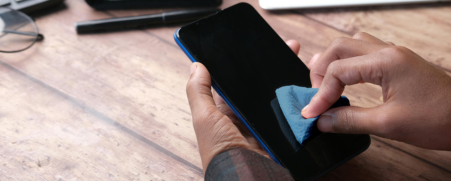 Cleaning a phone screen with a cloth