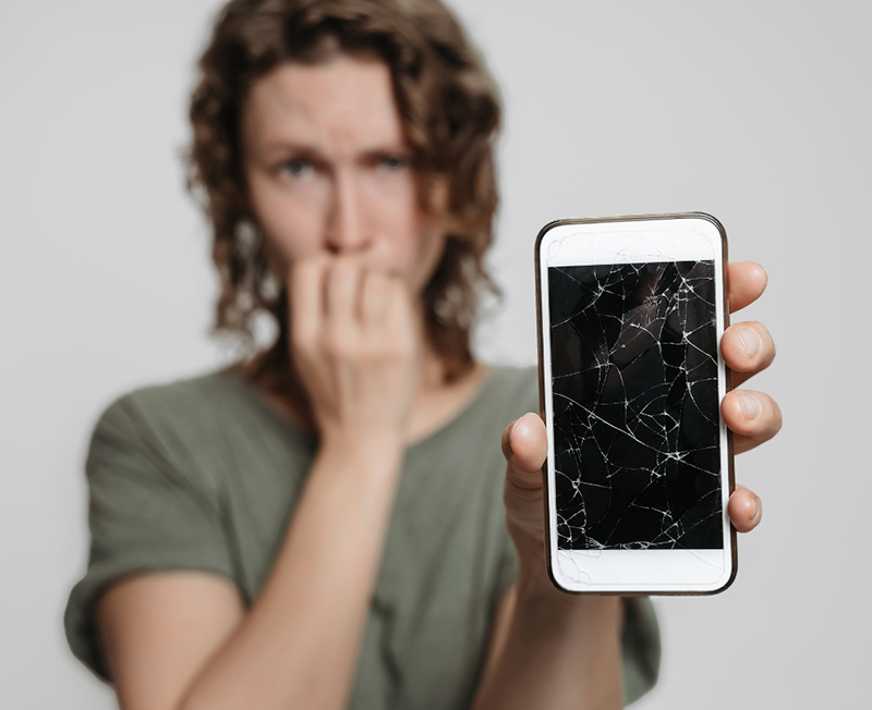 Woman holding broken phone