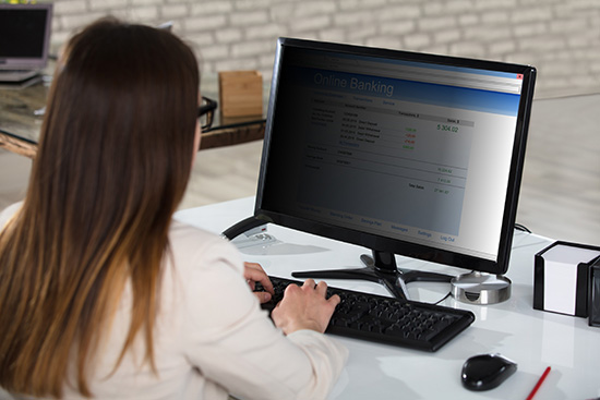 Woman on computer with privacy filter